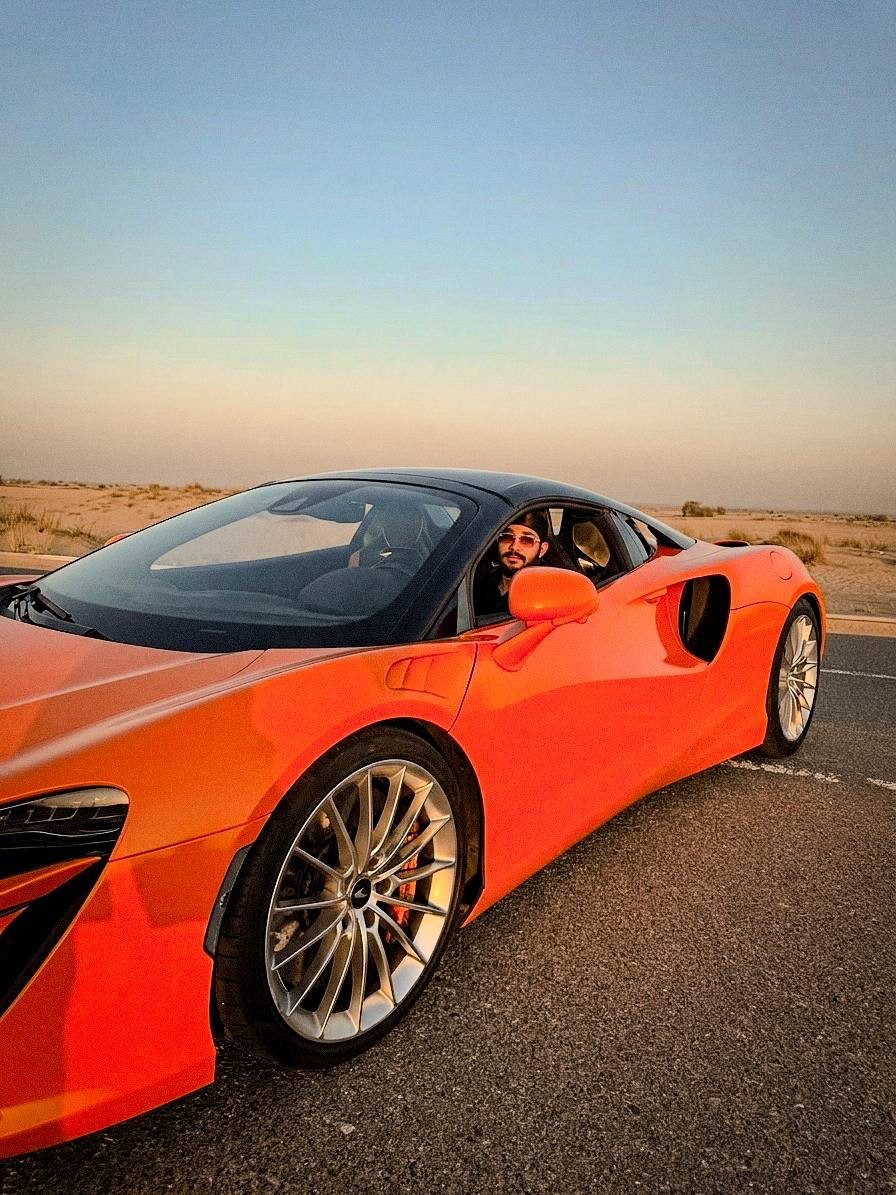 Jaidev Bhogal in an orange McLaren at sunset