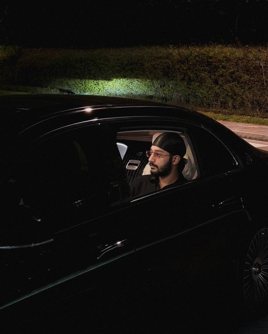 Jaidev Bhogal in the back of a black car at night